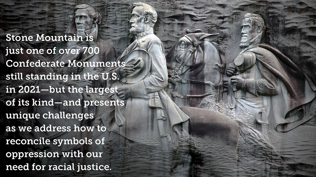 A stone monument with a few men.